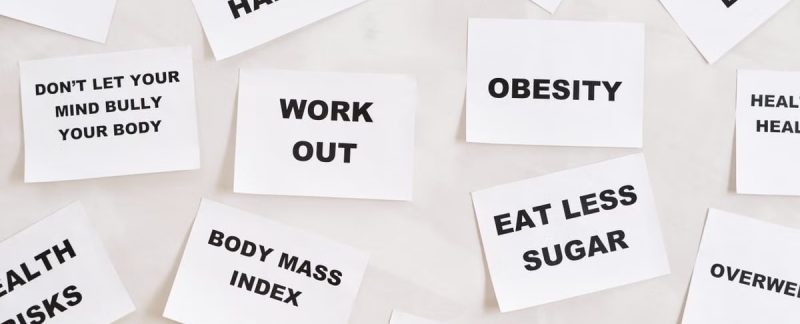 Collection of motivational quotes promoting health and wellness on paper cards.